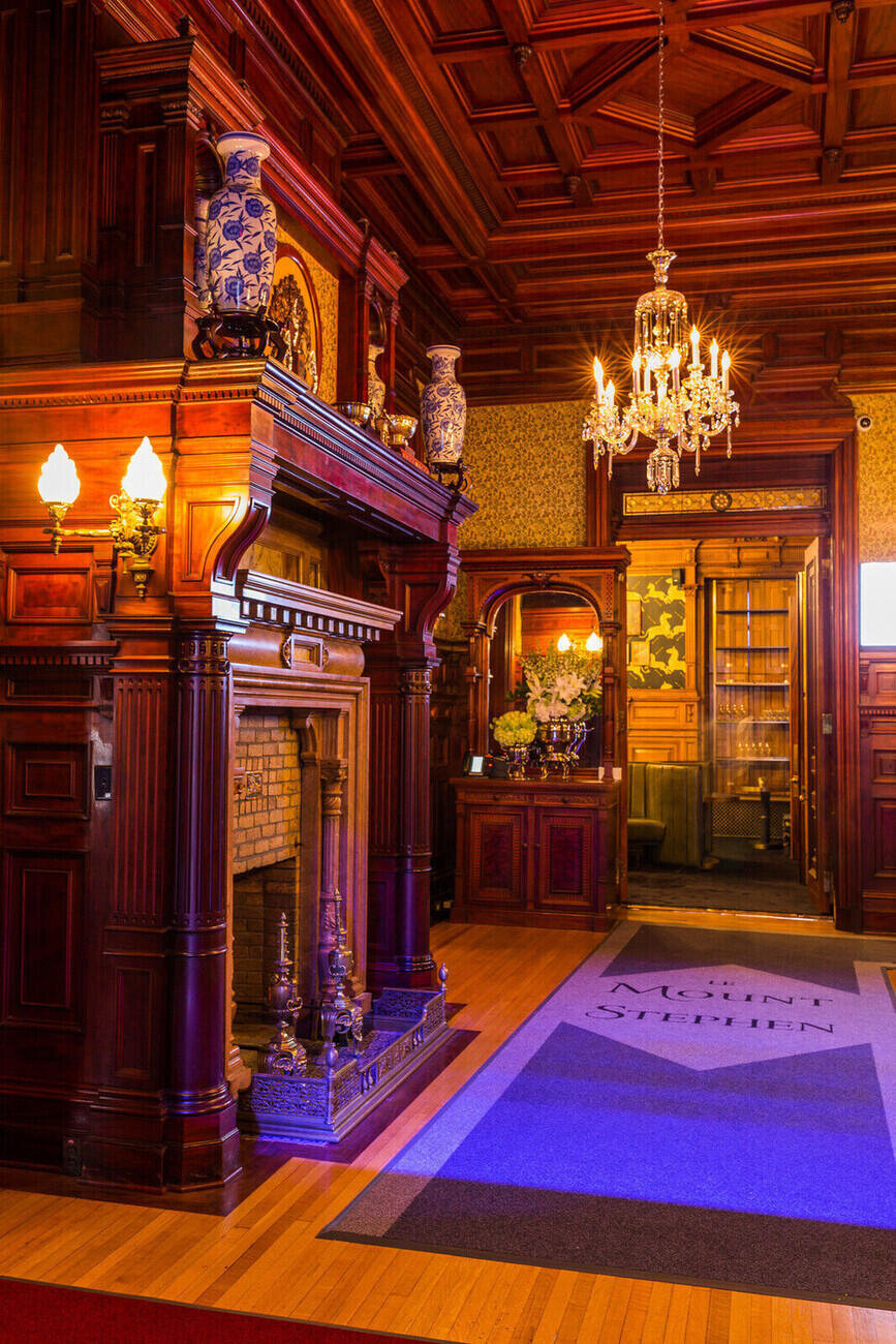 a room with a fireplace and chandeliers